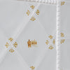 White tiles with mustard patterns on a white background