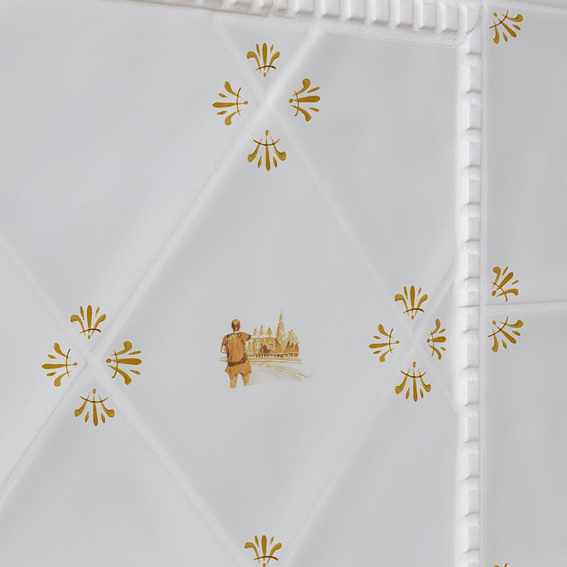 White tiles with mustard patterns on a white background