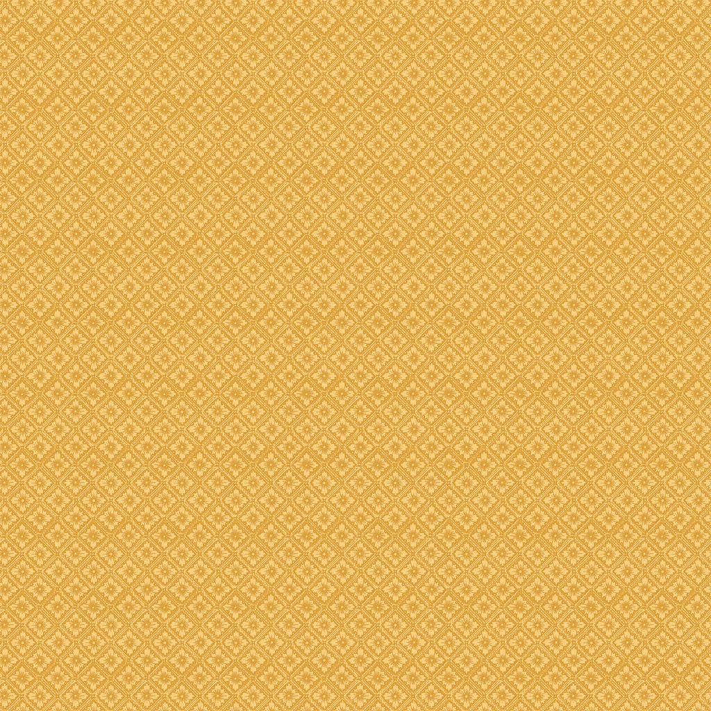 A close-up of a warm mustard yellow fabric or material with a repeating small geometric floral pattern.