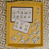 Two postcards showing different illustrated tile corners in a yellow tray with tile squares