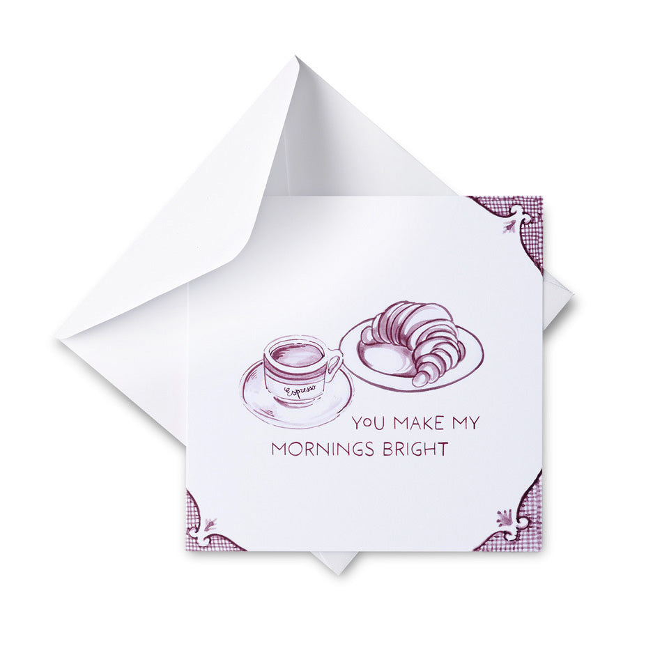 Greeting card with a cup of coffee and croissant illustration and text 'You make my mornings bright' on a white background.