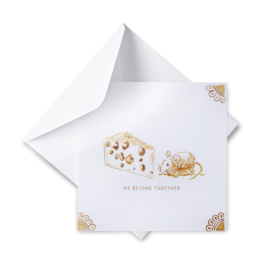 White card with gold illustrations of a cheese and a mouse, and the text 'We Belong Together', on a white background.